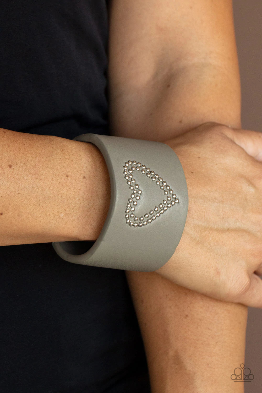 Paparazzi Accessories Rodeo Romance - Silver The center of an Ultimate Gray leather cuff is studded in a charming heart pattern, creating a rustically romantic look around the wrist. Sold as one individual bracelet. Jewelry