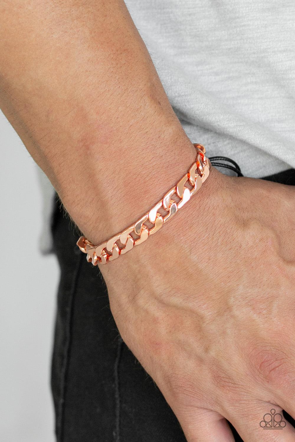 Paparazzi Accessories Score! - Copper Shiny black cording knots around the ends of a thick shiny copper curb chain that is wrapped across the top of the wrist for a versatile look. Features an adjustable sliding knot closure. Jewelry