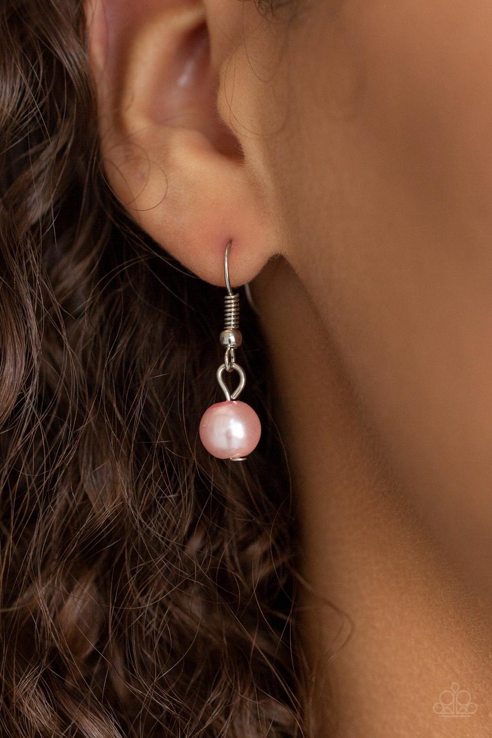 Paparazzi Accessories Bow Before The Queen - Pink A classic strand of pink pearls and dramatic silvery chain drape below the collar. Infused with heavy metal accents, teardrop and marquise cut white rhinestone frames connect into a show-stopping fringe. F