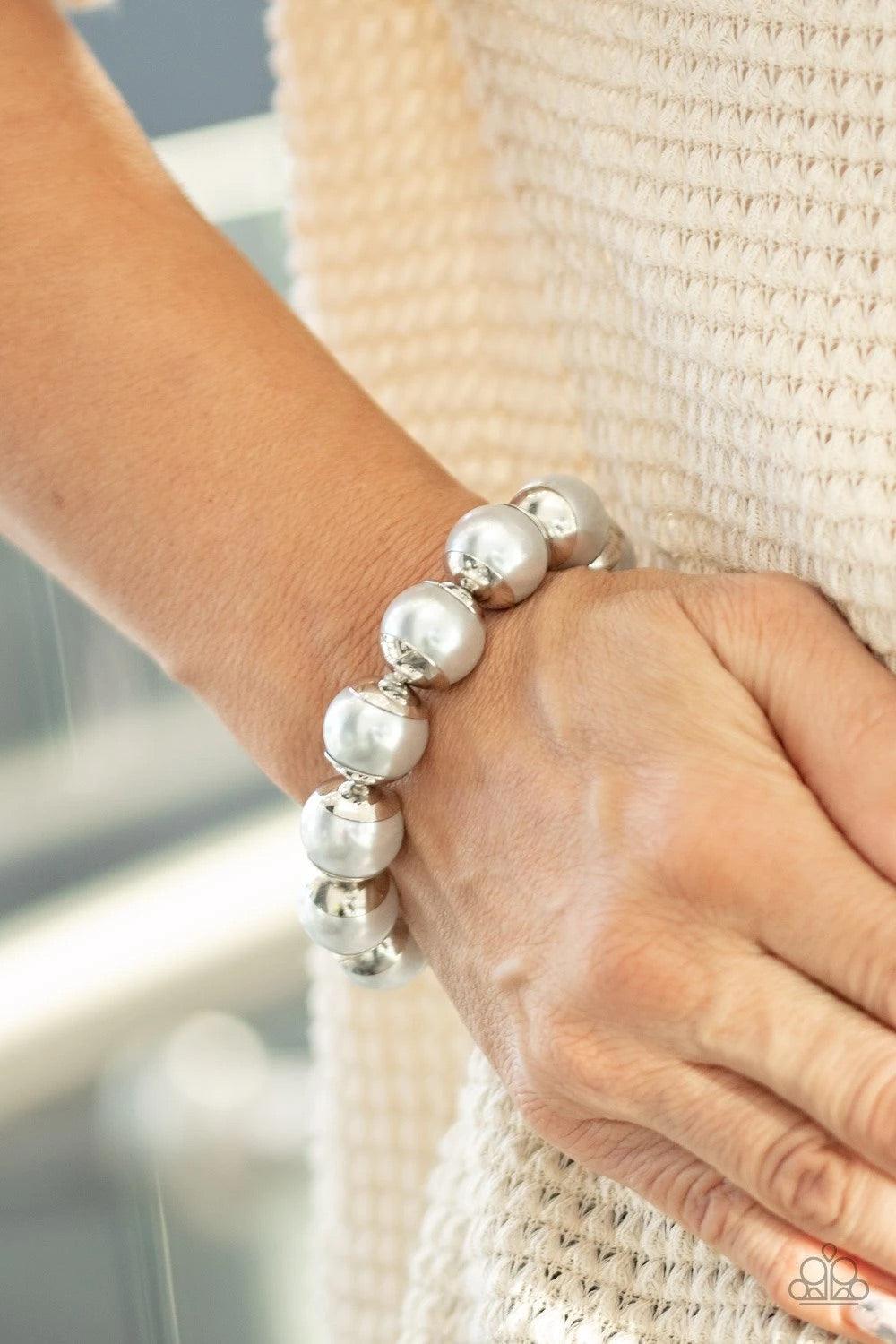 Paparazzi Accessories One Woman Show-STOPPER - Silver Capped in silver fittings, over-sized silver pearls are threaded along a stretchy band around the wrist for a refined look. Paparazzi Jewelry is lead-free and nickel-free. Sold as one individual bracel