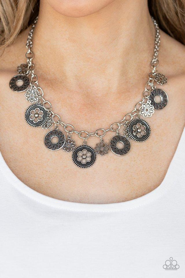 Paparazzi Accessories Meadow Masquerade - Silver A collection of antiqued floral charms dangles from a thick silver chain, creating a whimsical fringe below the collar. Features an adjustable clasp closure.Sold as one individual necklace. Includes one pai