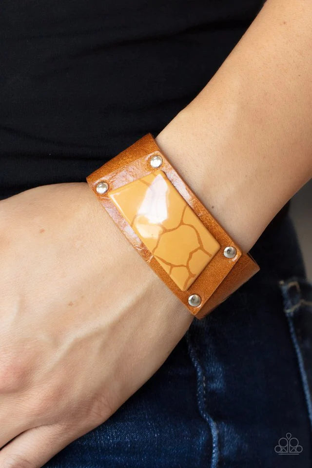 Paparazzi Accessories Geo Glamper - Orange Featuring a faux marble finish, a brown acrylic centerpiece attaches to a tan leather frame that is studded in place along a distressed tan leather band for a colorfully rustic fashion. Features an adjustable sna