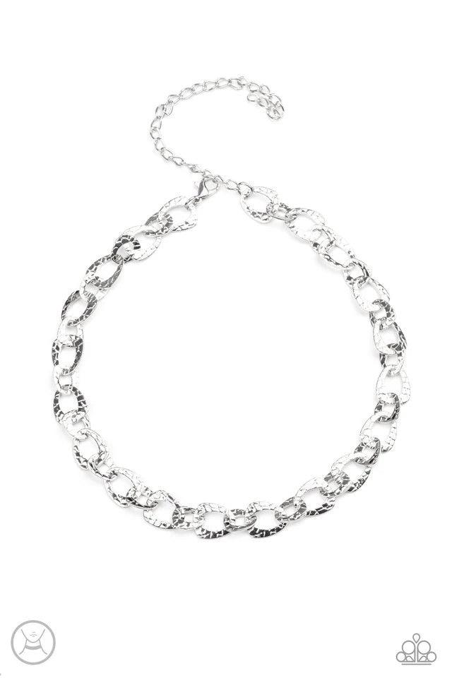 Paparazzi Accessories Urban Safari - Silver Embossed in a metallic crocodile-like print, asymmetrical silver links delicately connect around the neck for a wild industrial inspired look. Features an adjustable clasp closure. Necklaces