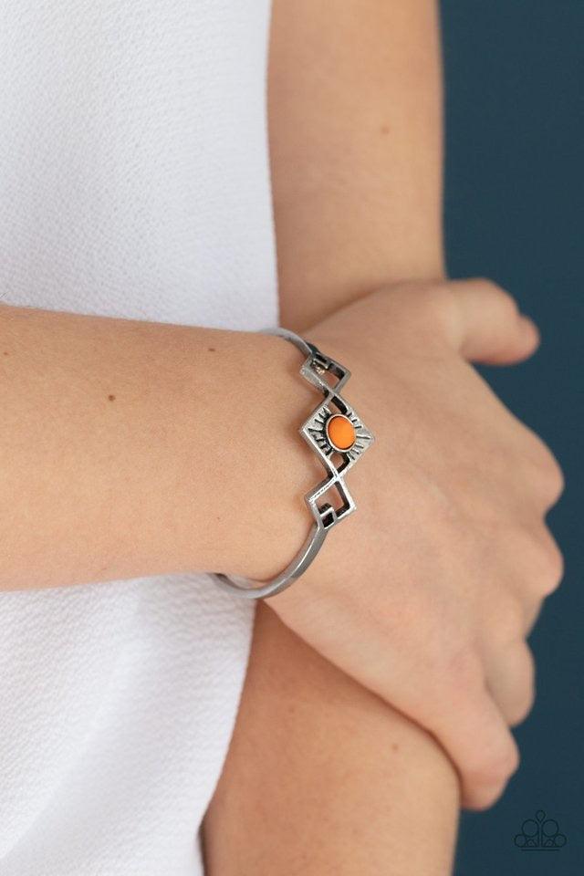 Paparazzi Accessories Dainty Deco - Orange Featuring an orange beaded center, tilted square frames attach to a dainty silver cuff, creating an abstract centerpiece. Sold as one individual bracelet. Jewelry
