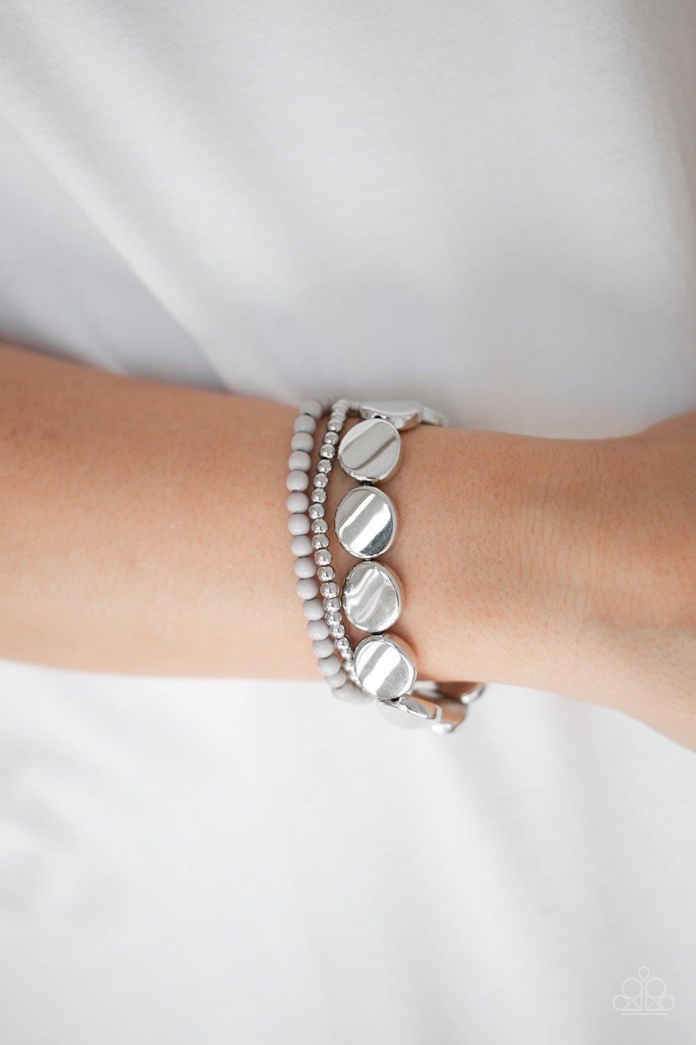 Paparazzi Accessories Beyond The Basics - Silver Mismatched silver and gray beads and round silver accents are threaded along stretchy bands, creating colorful layers around the wrist. Sold as one set of three bracelets. Jewelry