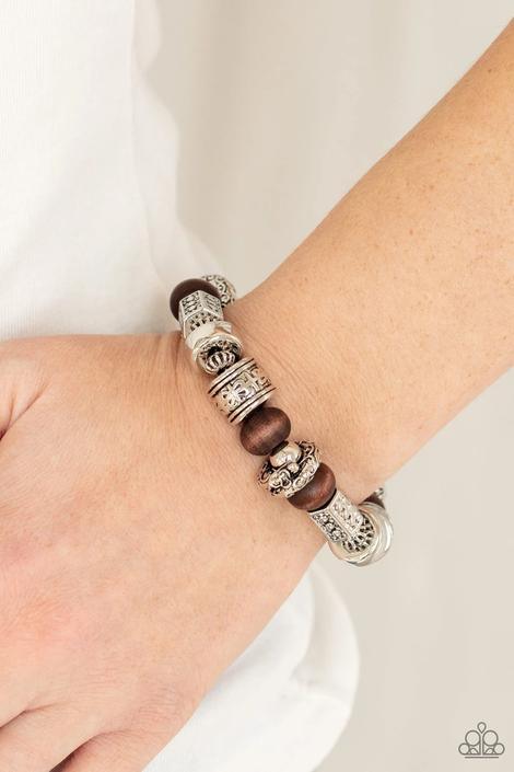 Paparazzi Accessories Exploring The Elements - Brown Stamped, studded, and embossed in tribal inspired patterns, a collection of chunky silver beads join earthy wooden beads along a stretchy band around the wrist for an earthy flair. Sold as one individua