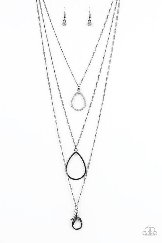 Paparazzi Accessories Make The World Sparkle - Black *Lanyard A white rhinestone encrusted teardrop gives way to a smooth gunmetal teardrop, creating refined layers down the chest. A lobster clasp hangs from the bottom of the design to allow a name badge
