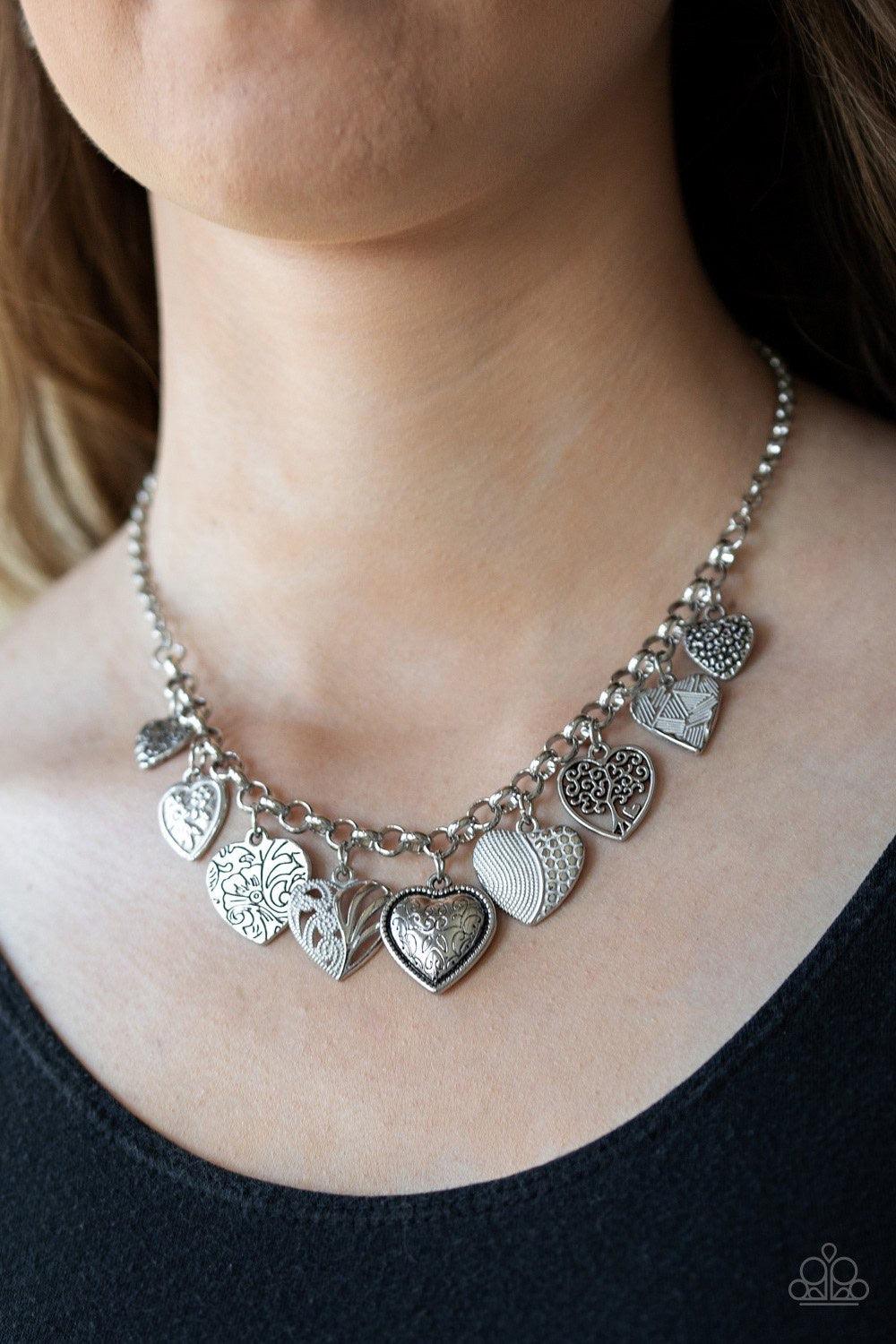 Paparazzi Accessories Grow Love - White Featuring an array of floral patterns, a collection of silver hearts swing from the bottom of a shimmery silver chain. Alternating charms are brushed in a shiny white finish, creating a colorful fringe below the col