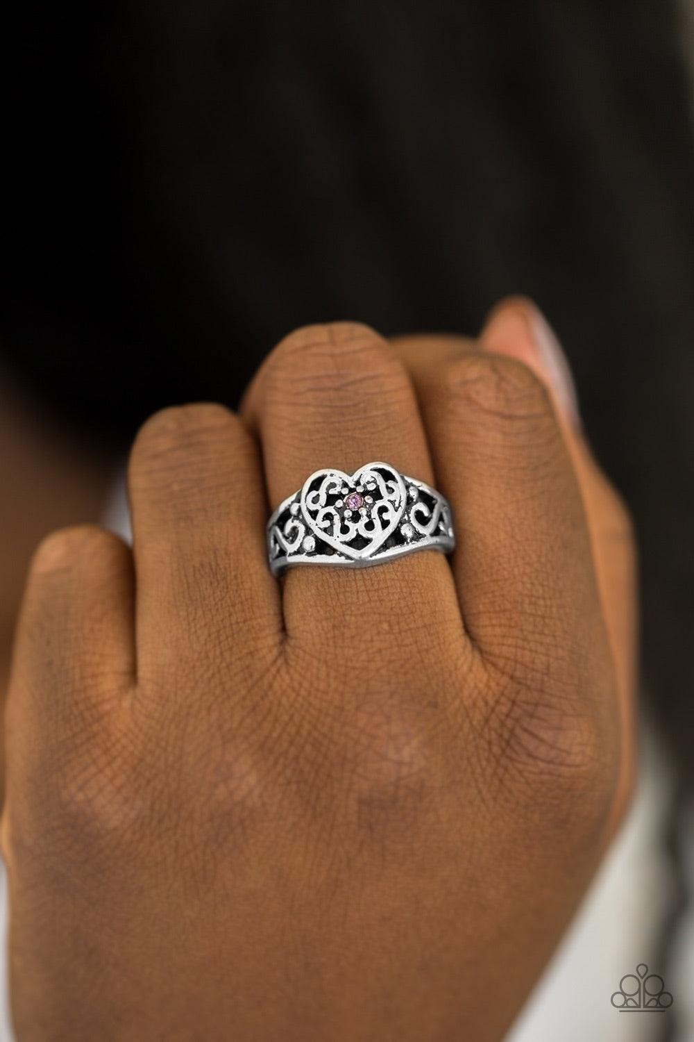 Paparazzi Accessories Dearly Beloved - Purple A dainty purple rhinestone dots the center of an ornate heart frame for a vintage inspired look. Features a dainty stretchy band for a flexible fit. Jewelry