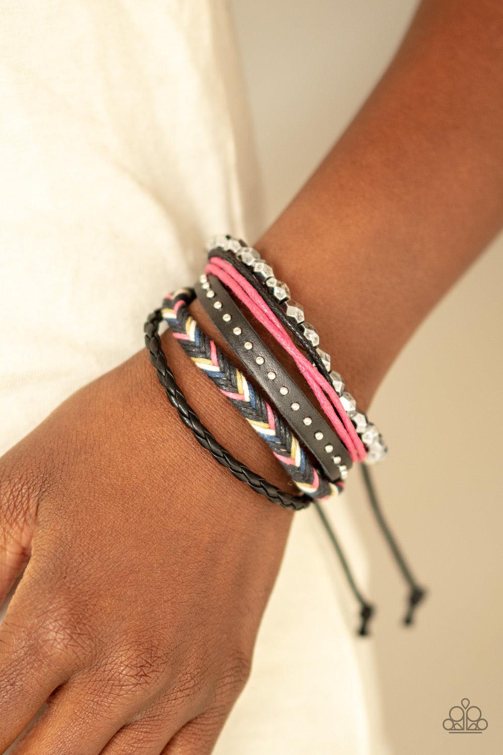 Paparazzi Accessories Wonderfully Wayfarer ~Pink Mismatched strands of silver beads, studded leather, braided leather, and pink and black cording layer around the wrist for a free-spirited style. Features an adjustable sliding knot closure. Sold as one in