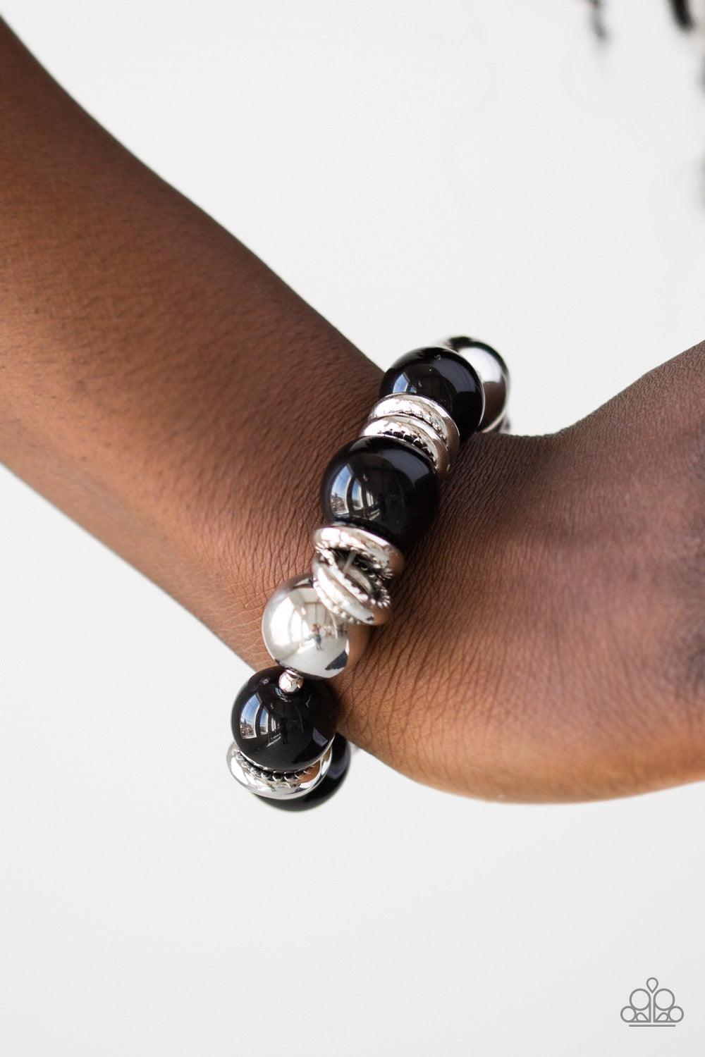 Paparazzi Accessories Rockin Rockefeller ~Black Dramatic black beads and shiny silver beads are threaded along an elastic stretchy band around the wrist. Glistening silver accents are sprinkled between the classic beads, adding depth and shimmer to the bu