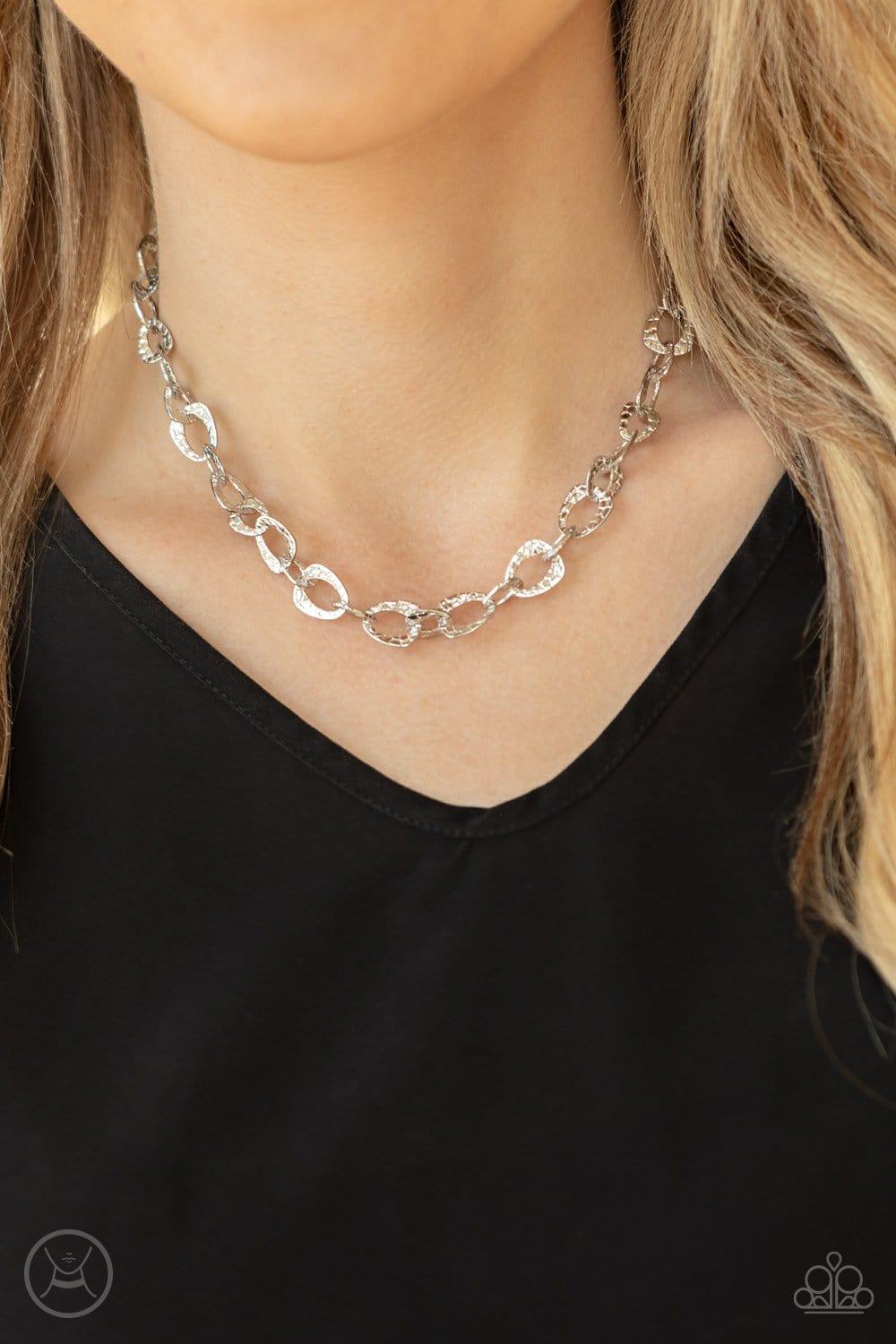 Paparazzi Accessories Urban Safari - Silver Embossed in a metallic crocodile-like print, asymmetrical silver links delicately connect around the neck for a wild industrial inspired look. Features an adjustable clasp closure. Necklaces