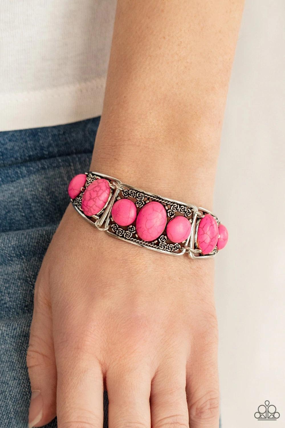 Paparazzi Accessories Southern Splendor Pink | Red stones are encrusted along the center of antiqued silver frames dotted with dainty rosebuds as they delicately connect into an adjustable cuff-like display around the wrist. Features an adjustable clasp c