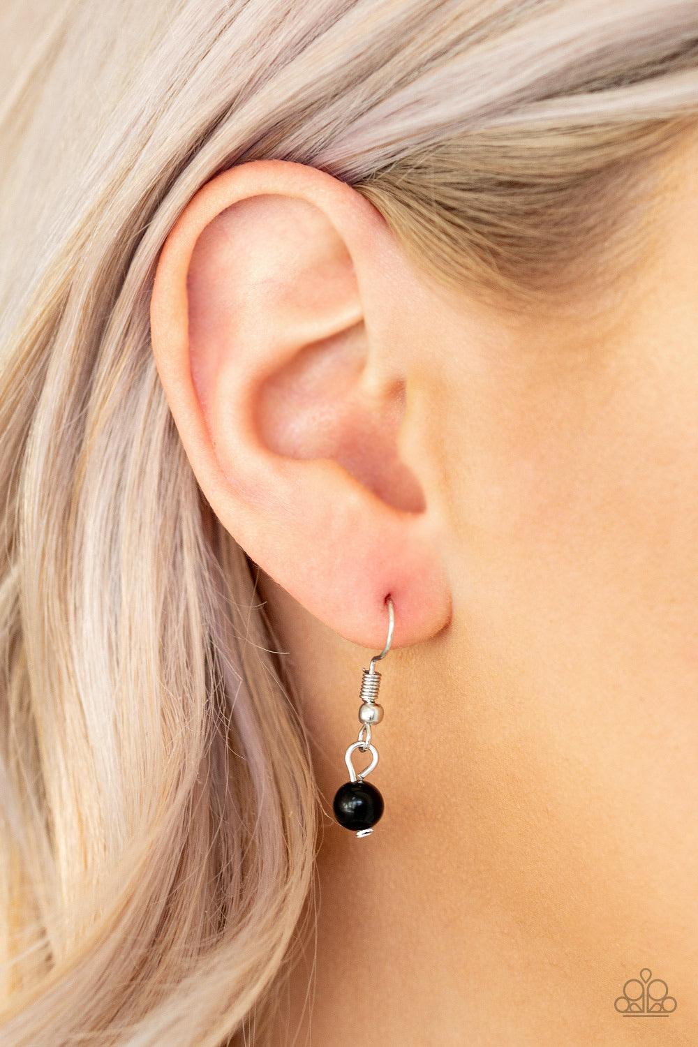 Paparazzi Accessories Time To Hit The ROAM - Black Rows of dainty silver and glassy black beads give way to two shimmery silver chain layers. A dainty black bead swings from the uppermost strand, while a glassy black stone pendant swings from the lowermos