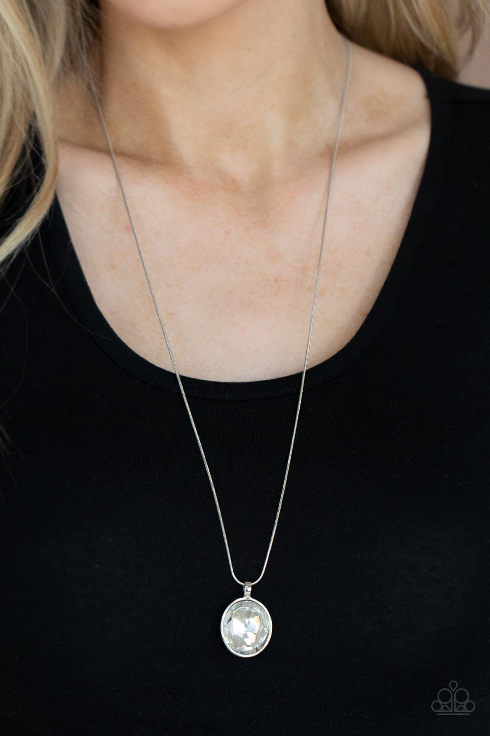 Paparazzi Accessories Instant Icon - White An oversized white gem is pressed into the center of a sleek silver fitting, creating a mesmerizing statement piece at the bottom of a sleek silver chain. Features an adjustable clasp closure. Sold as one individ