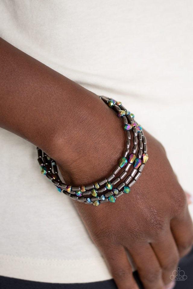 Paparazzi Accessories Regal Remix - Multi Varying in size and shape, iridescent gems and glistening gunmetal beads are threaded along a coiled wire, creating a regal infinity wrap style bracelet around the wrist. Jewelry