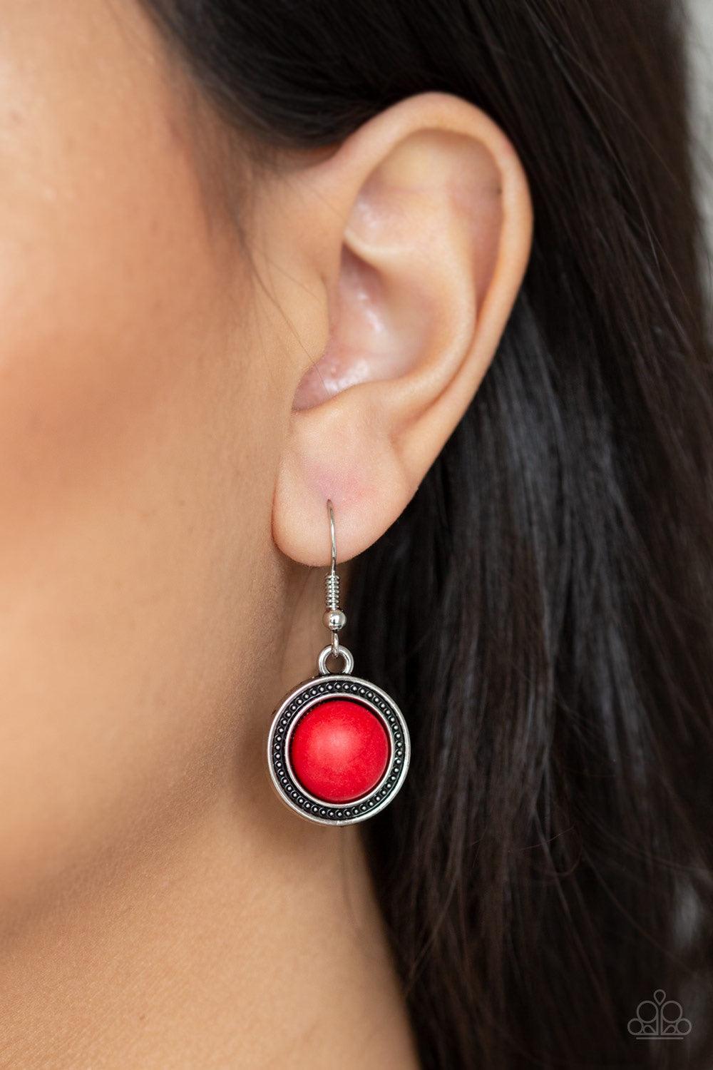 Paparazzi Accessories Lasting EMPRESS-ions - Red An antiqued silver plate, adorned in rippling circular textures, swings from the bottom of a pair of doubled silver chains. The ornate plate gives way to a dramatic red stone pendant bordered by tribal insp