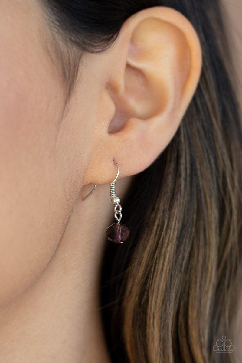 Paparazzi Accessories Distracted by Dazzle - Purple Attached to strands of shimmery silver chains, a glittery collection of purple, smoky, and white crystal-like gems and white rhinestone encrusted silver rings are threaded along an invisible wire below t
