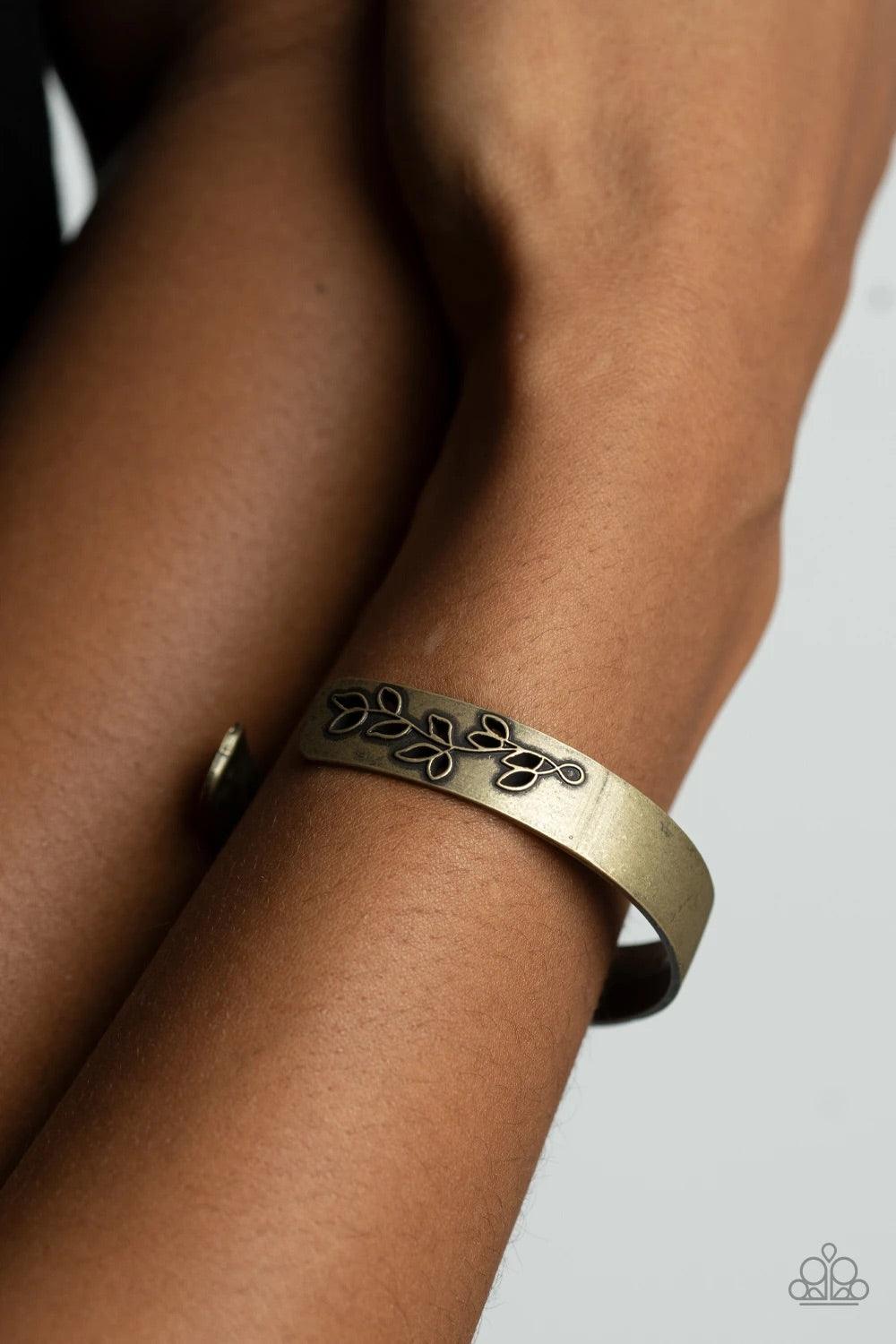 Paparazzi Accessories Frond Fable - Brass The ends of a dainty brass cuff is cutout and embossed in rustic leafy filigree, creating a simple seasonal centerpiece around the wrist. Sold as one individual bracelet. Jewelry