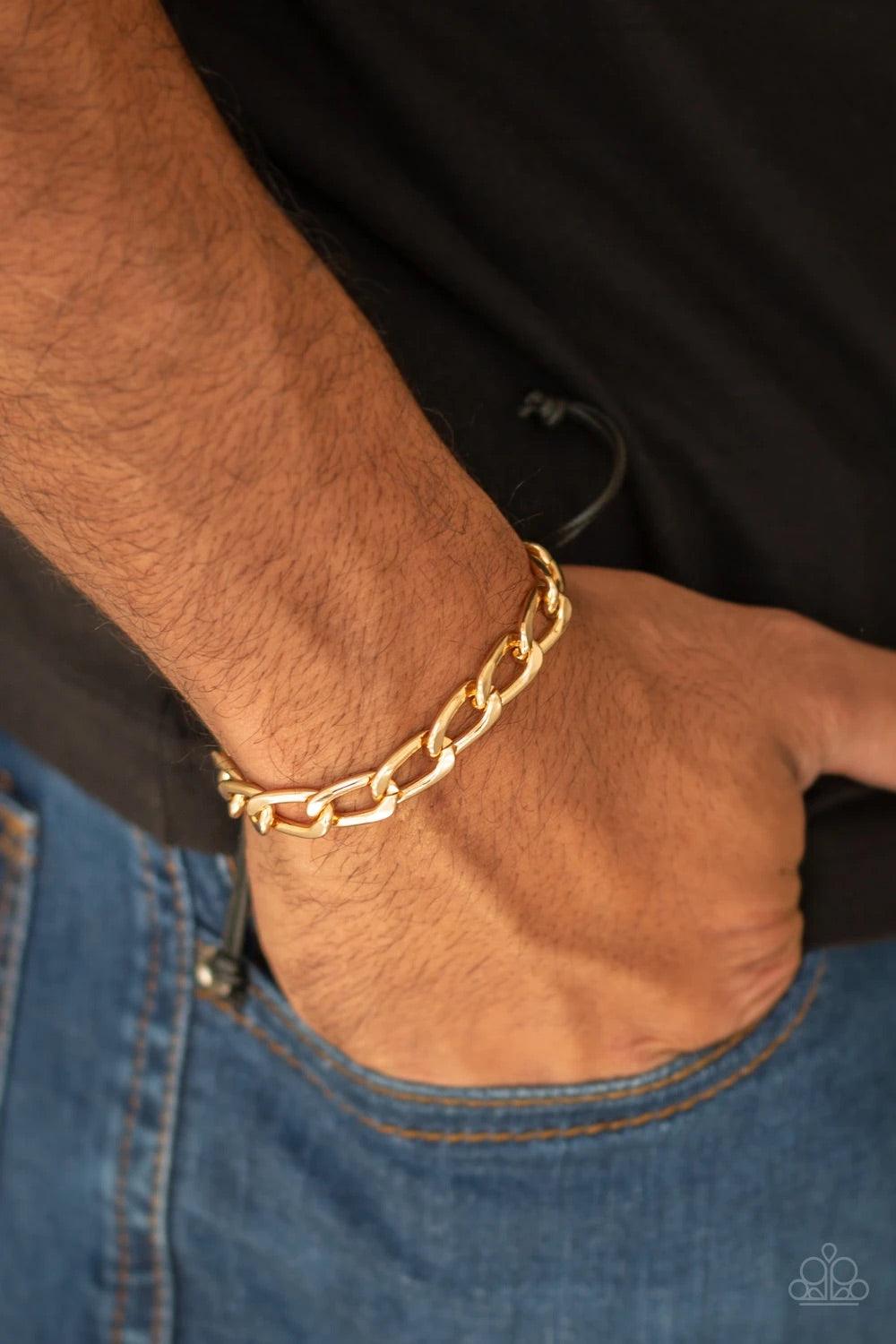 Paparazzi Accessories Goalpost - Gold Shiny black cording knots around the ends of a gold beveled cable chain that is wrapped across the top of the wrist for a versatile look. Features an adjustable sliding knot closure. Sold as one individual bracelet. J