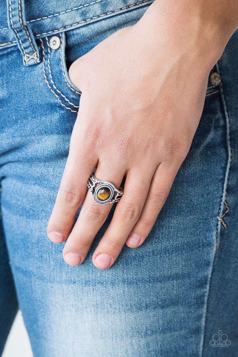 Paparazzi Accessories Peacefully Peaceful - Brown A tranquil tiger's eye stone is pressed into the center of a studded silver band for a seasonal look. Features a dainty stretchy band for a flexible fit. Jewelry