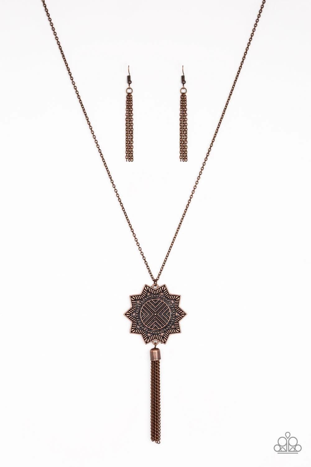 Paparazzi Accessories From Sunup To Sundown - Copper A textured sunburst pendant swings from the bottom of a lengthened copper chain. A shimmery copper chain tassel swings from the bottom of the tribal inspired pendant for a seasonal finish. Features an a