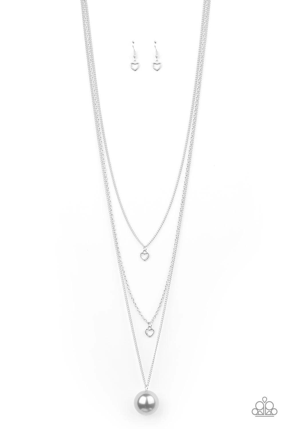 Paparazzi Accessories Hearty Heirloom - Silver Three shimmery silver chains cascade down the chest. Two dainty silver heart charms swing from the uppermost chains, giving way to a dramatically oversized silver pearl for a romantic finish. Features an adju