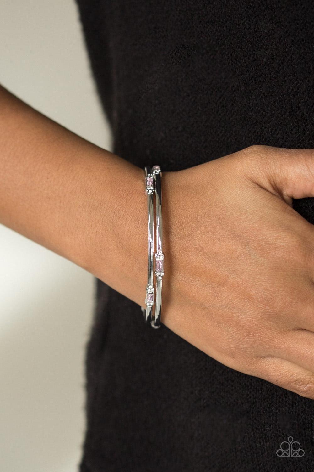 Paparazzi Accessories BRIGHT Here, BRIGHT Now - Pink Featuring elegant round and emerald style cuts, glittery pink and white rhinestones are pressed into two shimmery silver bangles for a refined look. Jewelry
