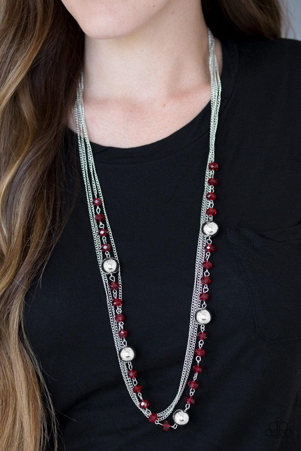 Paparazzi Accessories High Standards - Red Infused with rows of shimmery silver chains, a strand of glittery red crystal-like beads and classic silver accents drape across the chest for a regal finish. Features an adjustable clasp closure. Sold as one ind