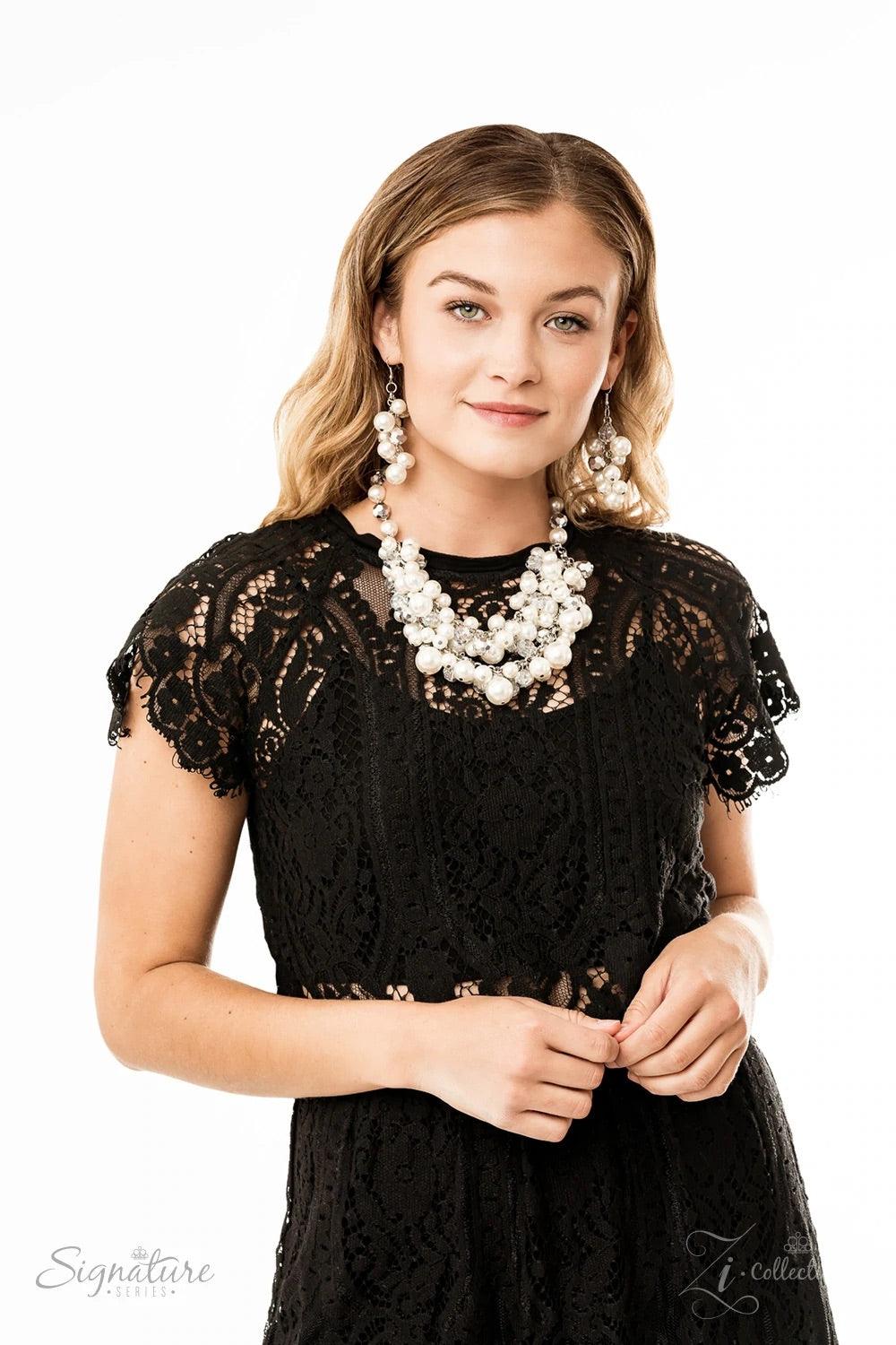 Paparazzi Accessories The Lauren A timeless collection of bubbly white pearls and faceted crystal-like beads dances along the collar in two rows of dramatic clusters. One side of the glassy crystals have been dipped in a flashy metallic finish, adding som
