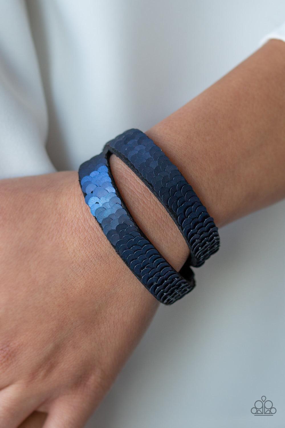 Paparazzi Accessories Under The SEQUINS ~Blue Row after row of shimmery sequins are stitched across the front of a lengthened black suede band. The elongated band allows for a trendy double wrap design. Bracelet features reversible sequins that change fro