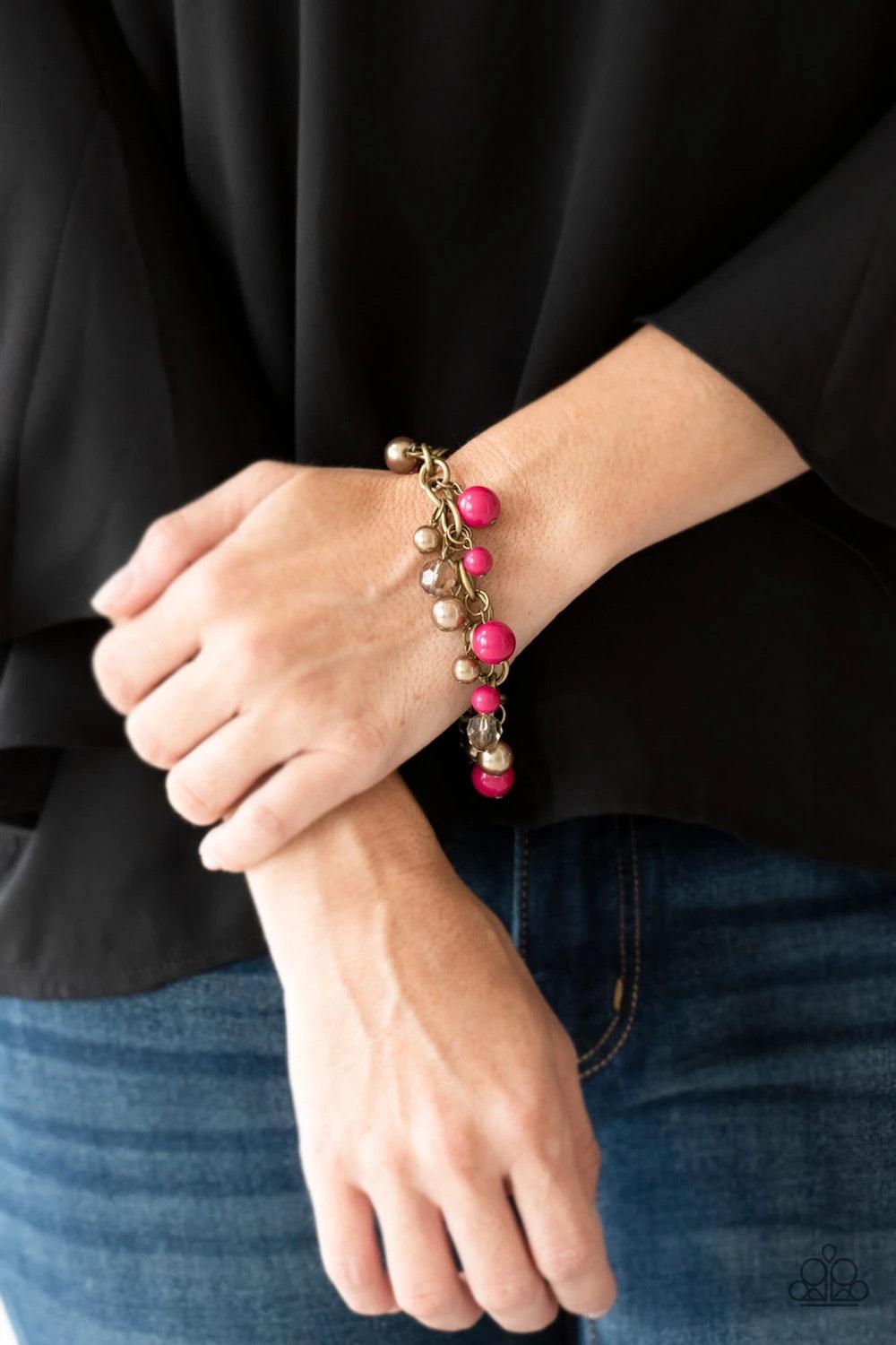 Paparazzi Accessories Grit and Glamour - Pink Pearly brass, polished pink, and glittery crystal-like beads swing from a bold brass chain, creating a refined fringe around the wrist. Features an adjustable clasp closure. Sold as one individual bracelet. Je