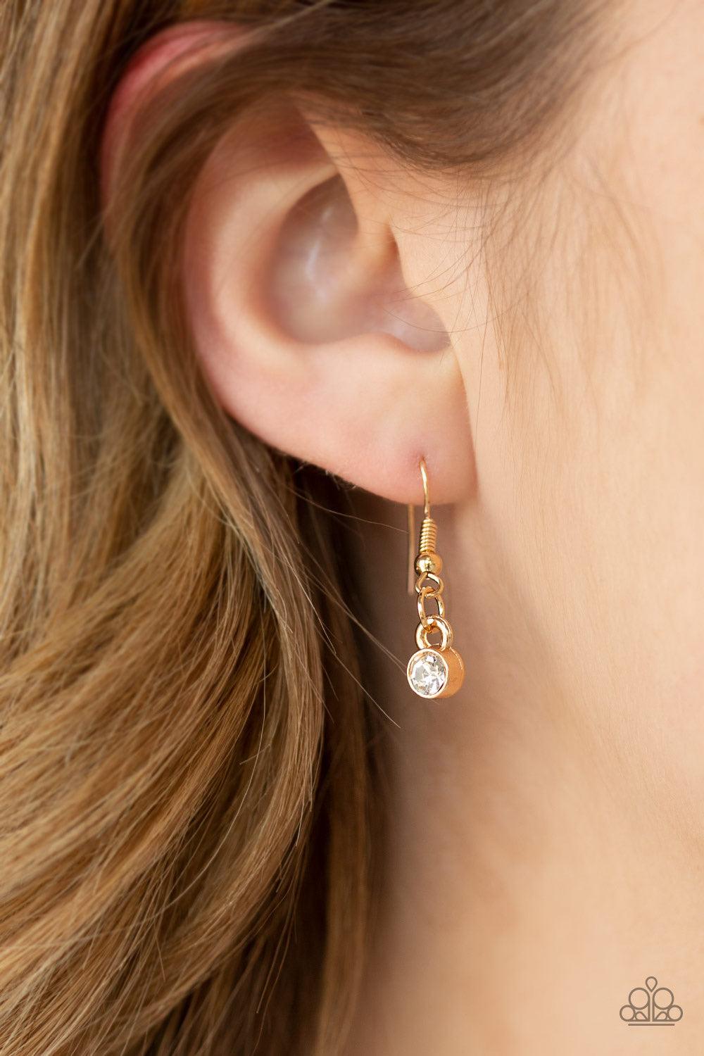 Paparazzi Accessories Bad HEIR Day - Gold Encrusted in row after row of glittery white rhinestones, an oversized round pendant swings from the bottom of a lengthened gold chain for a blinding look. Features an adjustable clasp closure. Jewelry