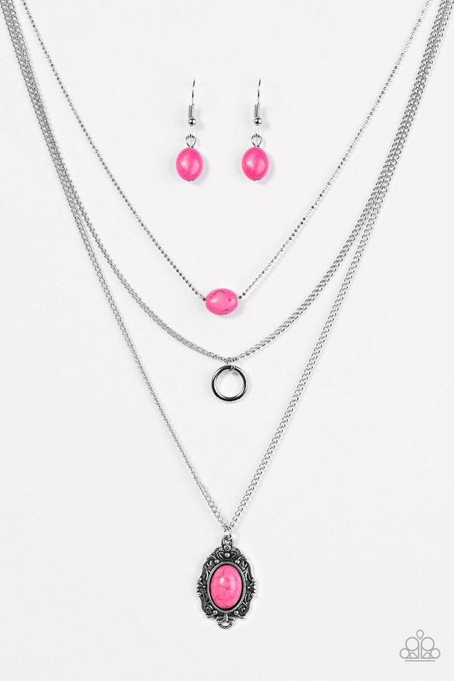 Paparazzi Accessories Canyon Cavalier - Pink A vivacious pink stone is suspended from the uppermost chain above a shimmery silver hoop and a pink stone pendant. Brushed in an antiqued shimmer, a regal silver frame encircles a pink stone, creating a whimsi