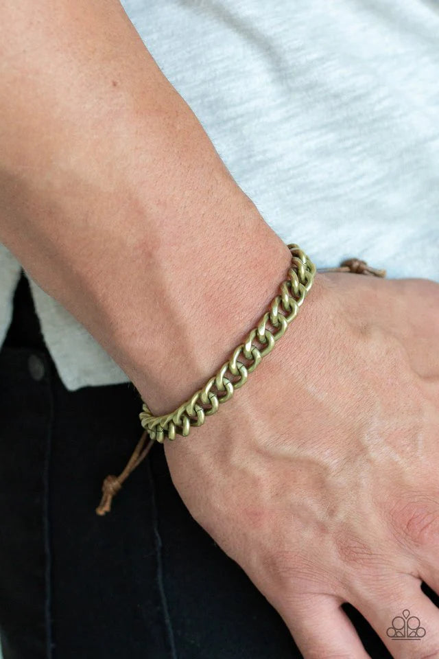 Paparazzi Accessories Blitz - Brass Shiny brown cording knots around the ends of a brass beveled cable chain that is wrapped across the top of the wrist for a versatile look. Features an adjustable sliding knot closure. Jewelry