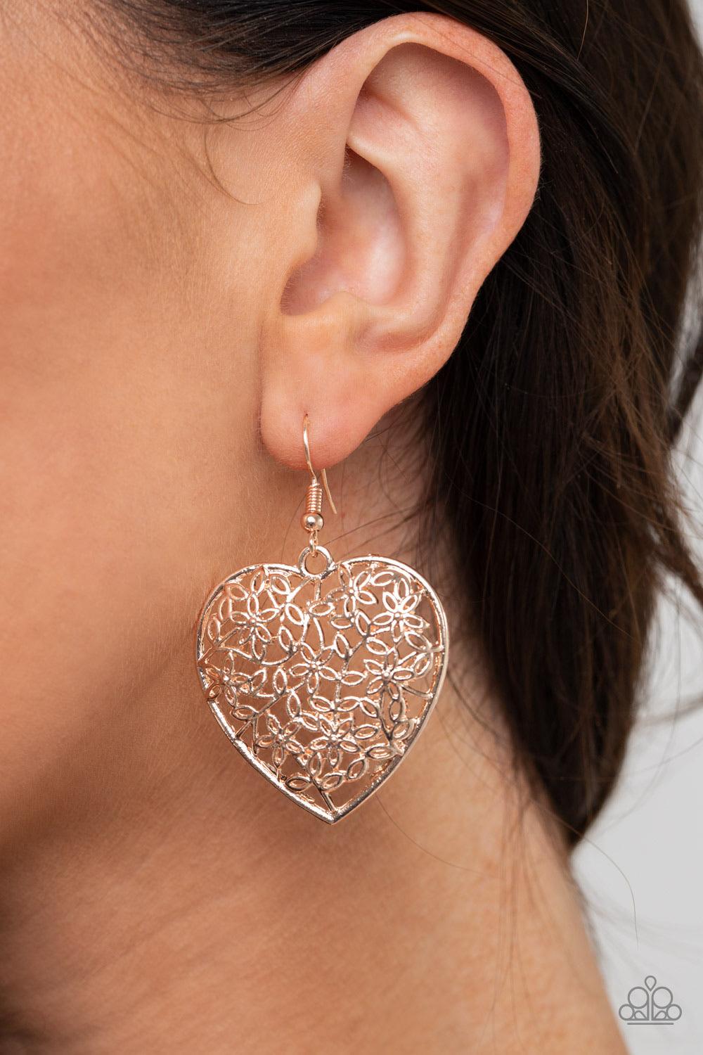 Paparazzi Accessories Let Your Heart Grow - Rose Gold Glistening floral filigree collects inside a rose gold heart, creating a whimsical frame. Earring attaches to a standard fishhook fitting. Sold as one pair of earrings. Jewelry