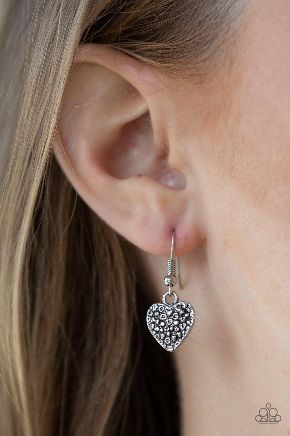 Paparazzi Accessories Grow Love - White Featuring an array of floral patterns, a collection of silver hearts swing from the bottom of a shimmery silver chain. Alternating charms are brushed in a shiny white finish, creating a colorful fringe below the col