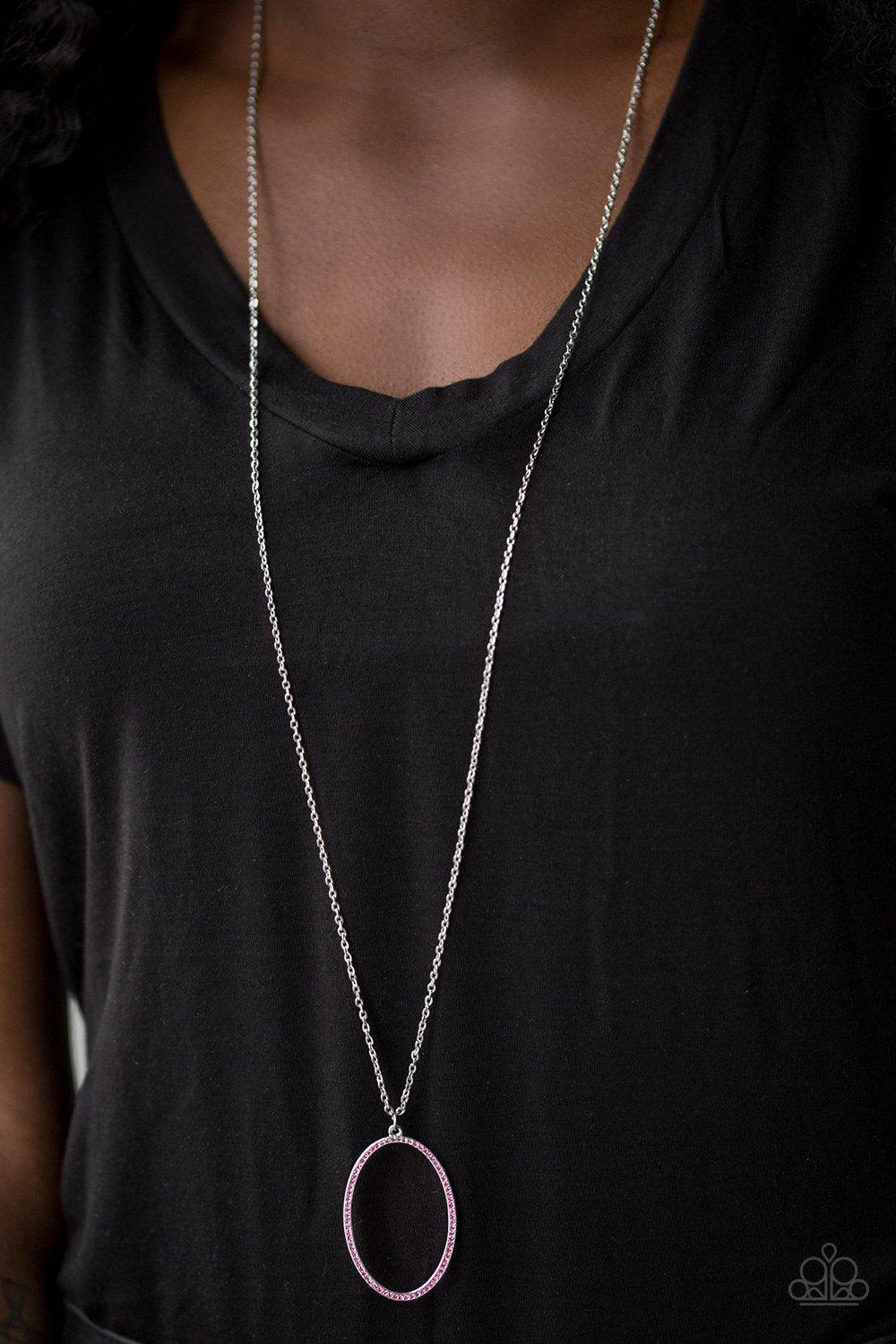 Paparazzi Accessories A Dazzling Distraction - Pink Encrusted in glassy pink rhinestones, an airy silver hoop swings from the bottom of a lengthened silver chain for a refined flair. Features an adjustable clasp closure. Sold as one individual necklace. I