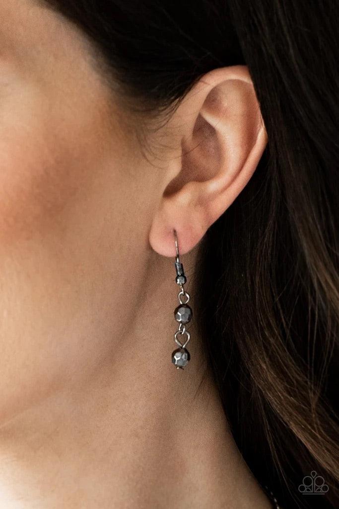 Paparazzi Accessories Rebel Remix - Black Strands of faceted gunmetal beads and glistening gunmetal chains stream from a matching gunmetal chain, creating an edgy fringe below the collar. Features an adjustable clasp closure. Sold as one individual neckla