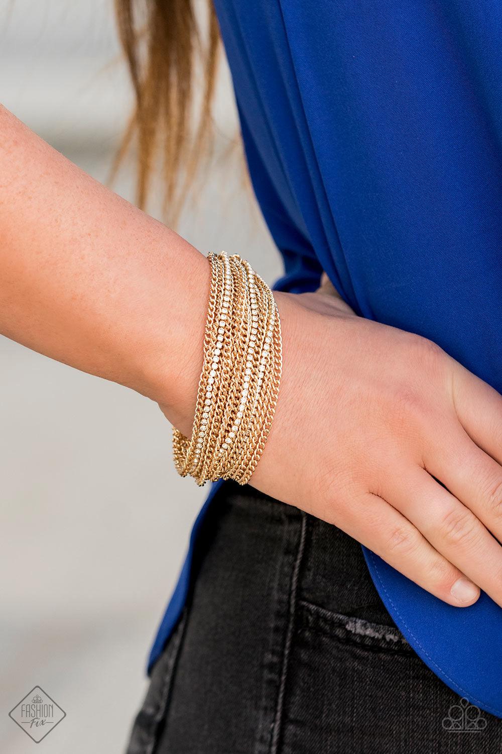 Paparazzi Accessories Pour Me Another - Gold Infused with sporadic strands of glittery white rhinestones, countless shiny gold chains layer around the wrist to create a dramatic shimmer. Features an adjustable clasp closure. Jewelry