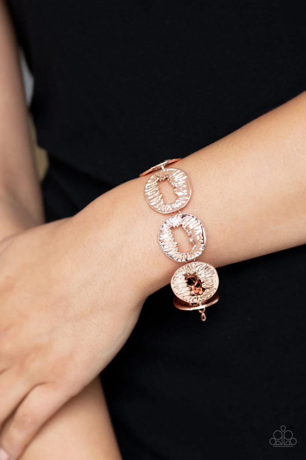 Paparazzi Accessories Cut It Out - Copper Featuring asymmetrical cutout centers, textured shiny copper discs connect across the wrist for an abstract look. Features an adjustable clasp closure. Sold as one individual bracelet. Jewelry