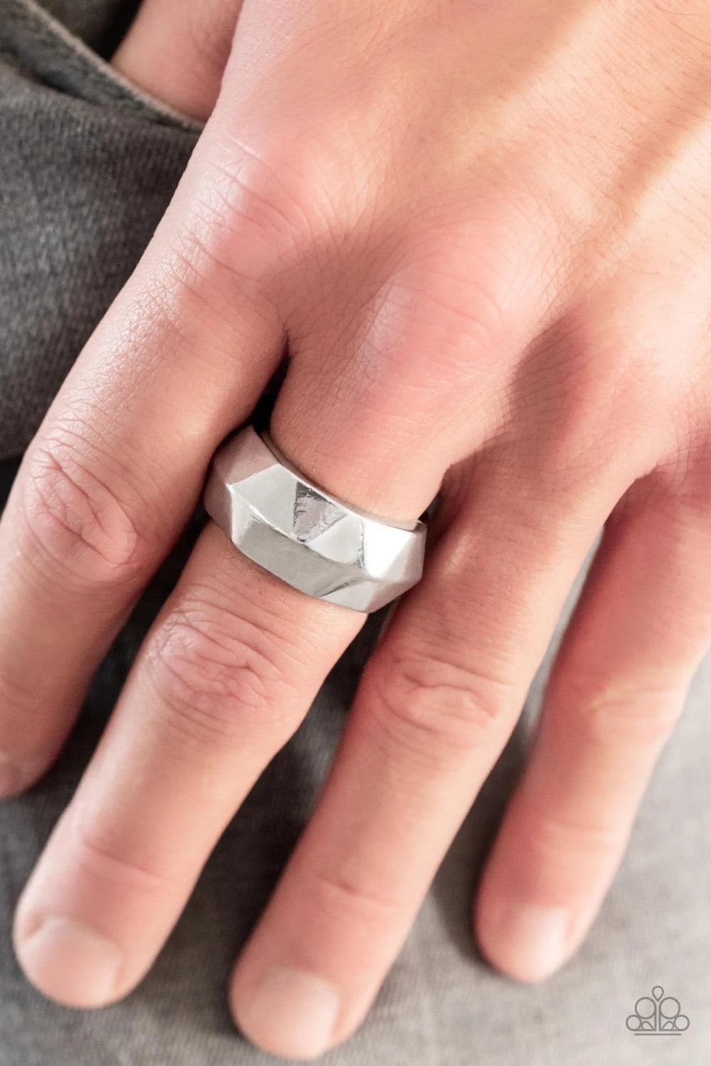 Paparazzi Accessories Industrial Mechanic - Silver Featuring an edgy geometric faceted surface, a thick silver band arcs across the finger. Features a stretchy band for a flexible fit. Jewelry