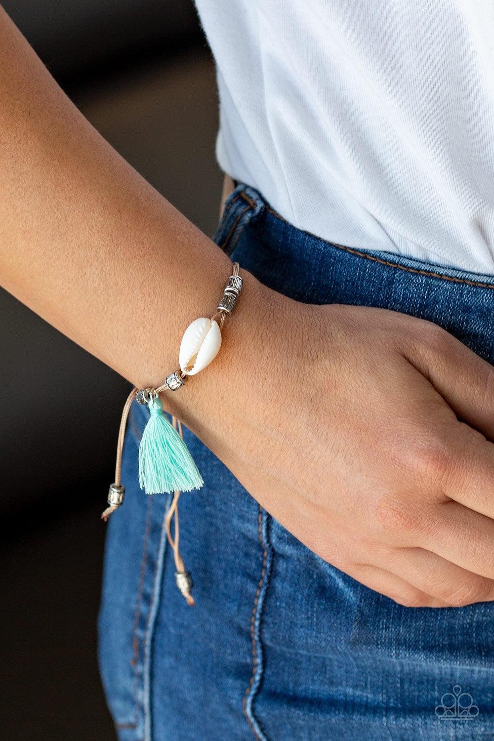 Paparazzi Accessories SEA If I Care - Green Infused with antiqued silver beads, a green threaded tassel and dainty white seashell slide along strips of shiny brown cording around the wrist for a summery look. Features an adjustable sliding knot closure. J