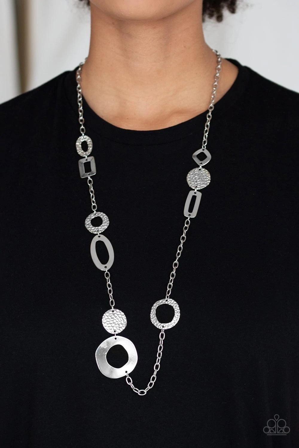Paparazzi Accessories Metro Scene - Silver A collection of mismatched smooth and textured silver frames connect into an abstract chain across the chest. Features an adjustable clasp closure. Sold as one individual necklace. Includes one pair of matching e