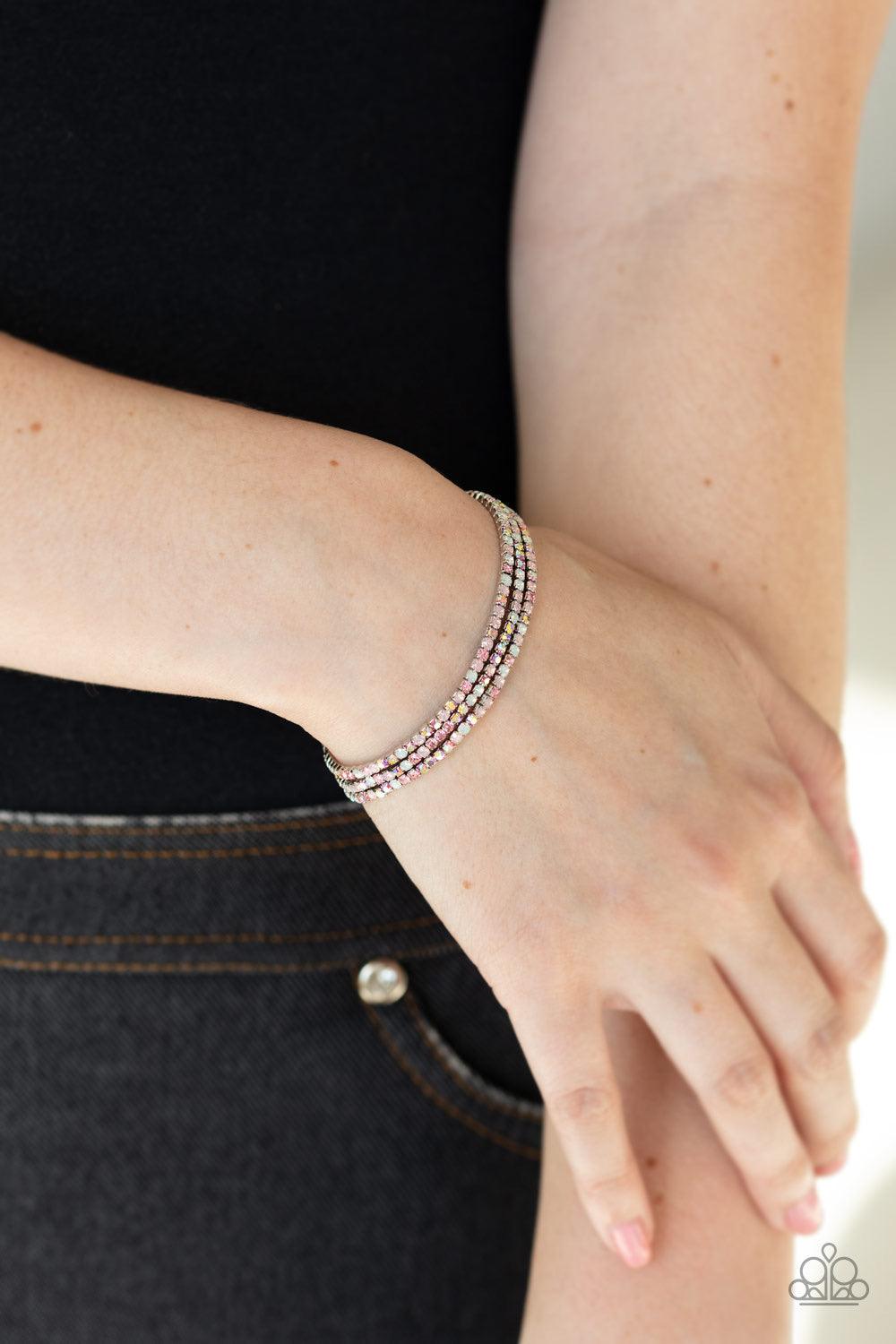 Paparazzi Accessories Sugar and Ice - Pink Featuring classic and opalescent finishes, a collection of dainty pink and white rhinestones are threaded along stretchy bands, creating glittery layers across the wrist. Jewelry
