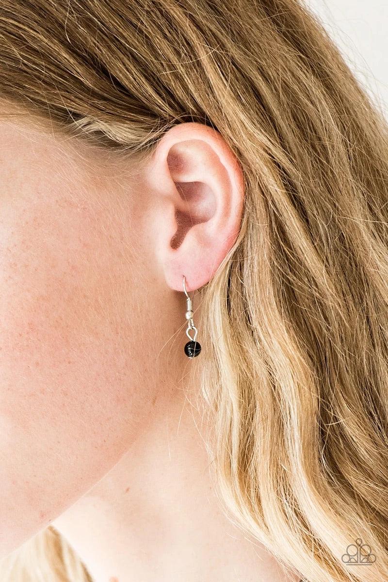 Paparazzi Accessories A Touch of CLASSY - Black Infused with silver chain, shiny black beads are threaded along an invisible wire below the collar. Matching black beads and glittery white rhinestones swing from the pearly strand, creating a flirtatious fr