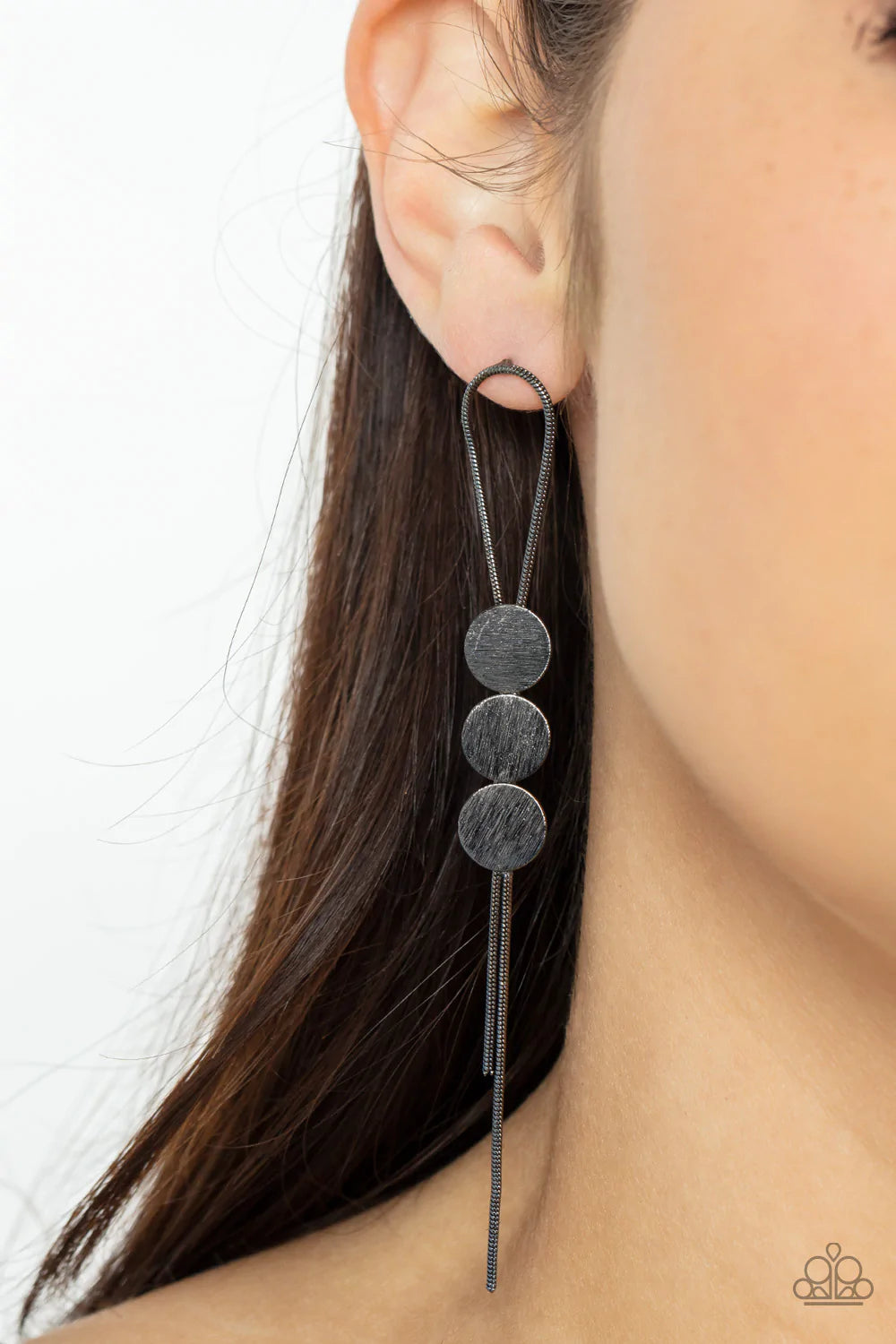 Paparazzi Accessories Bolo Beam - Black A gunmetal loop of round snake chain is held in place by a trio of scratched gunmetal discs, creating a trendy bolo-like lure. Earring attaches to a standard post fitting. Sold as one pair of post earrings. Jewelry