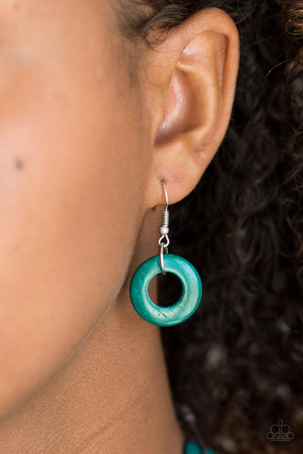 Paparazzi Accessories Waikiki Winds - Blue Shiny brown cording knots around refreshing blue wooden discs, creating a colorful display across the chest. Features a button loop closure. Sold as one individual necklace. Includes one pair of matching earrings