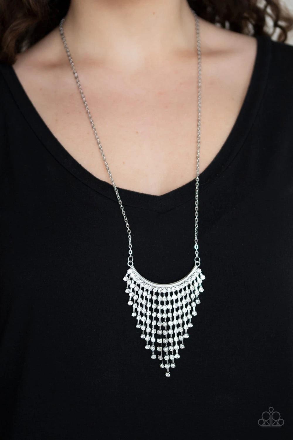Paparazzi Accessories Glitter Bomb - White Chains of glittery white rhinestones stream from the bottom of a bowing silver bar, creating a tapered fringe at the bottom of a lengthened silver chain. Features an adjustable clasp closure. Sold as one individu