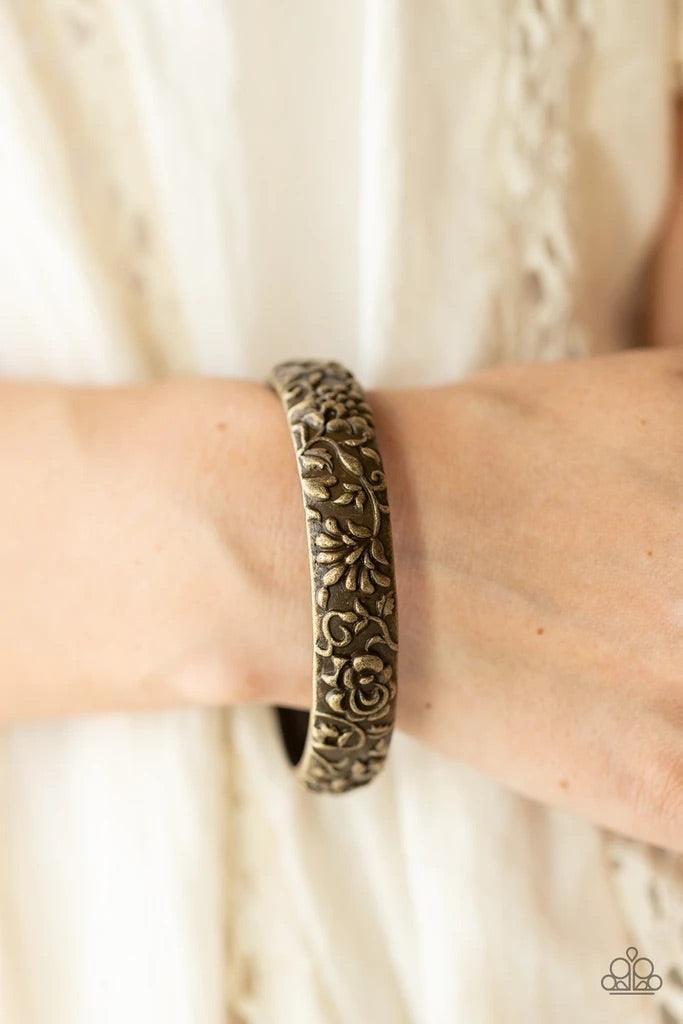 Paparazzi Accessories Victorian Meadow - Brass An antiqued brass bangle is delicately embossed in rustic floral patterns, creating a vintage inspired look around the wrist. Sold as one individual bracelet. Jewelry